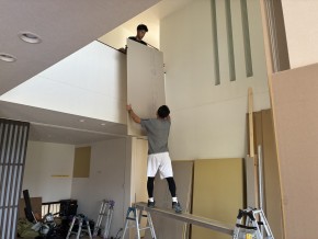 大工さんがボードをあげている様子